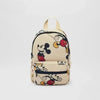 A beige backpack featuring a black and white Mickey Mouse print.