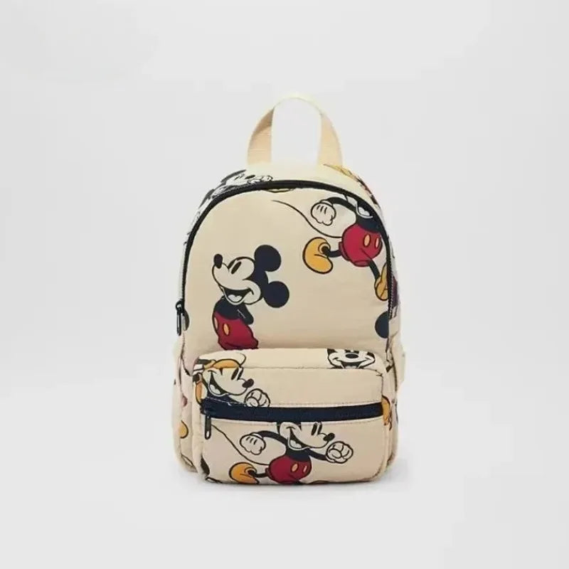 A beige backpack featuring a black and white Mickey Mouse print.