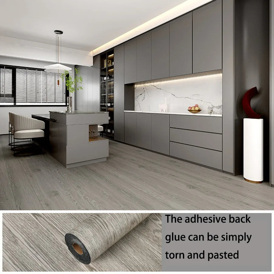 A roll of wood grain peel and stick wall decals showing the texture and adhesive backing.