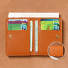An orange brown ultra-thin PU leather compact wallet holding various credit cards and an ID card.