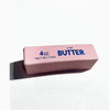 A pink butter fidget stick labeled 4 oz salted butter net weight.