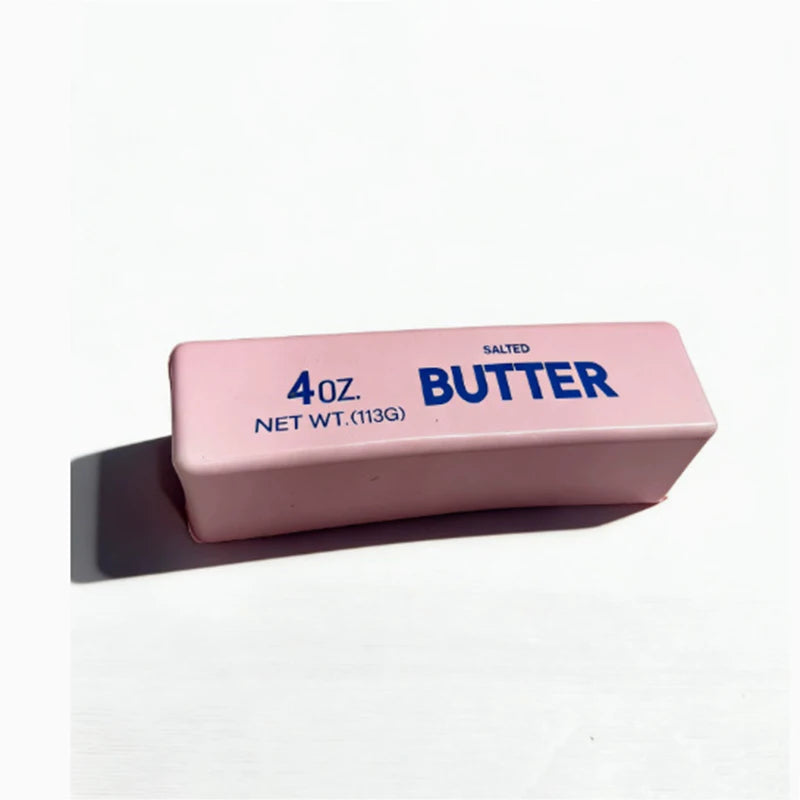 A pink butter fidget stick labeled 4 oz salted butter net weight.