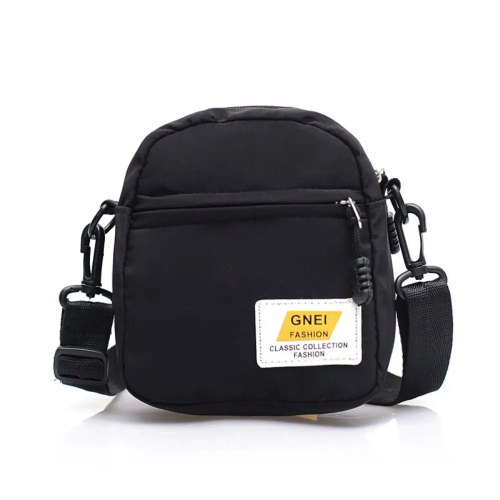 Black Japanese style mini canvas crossbody bag with a yellow label