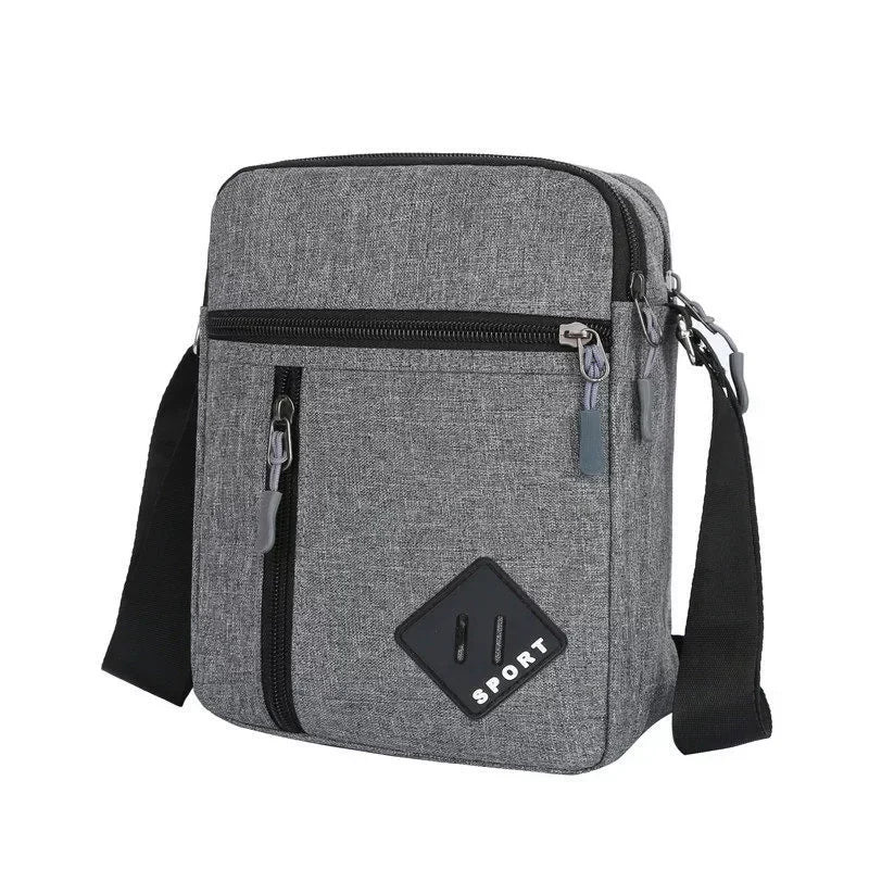 A gray men's lightweight crossbody sling bag with multiple zip pockets and a black strap.