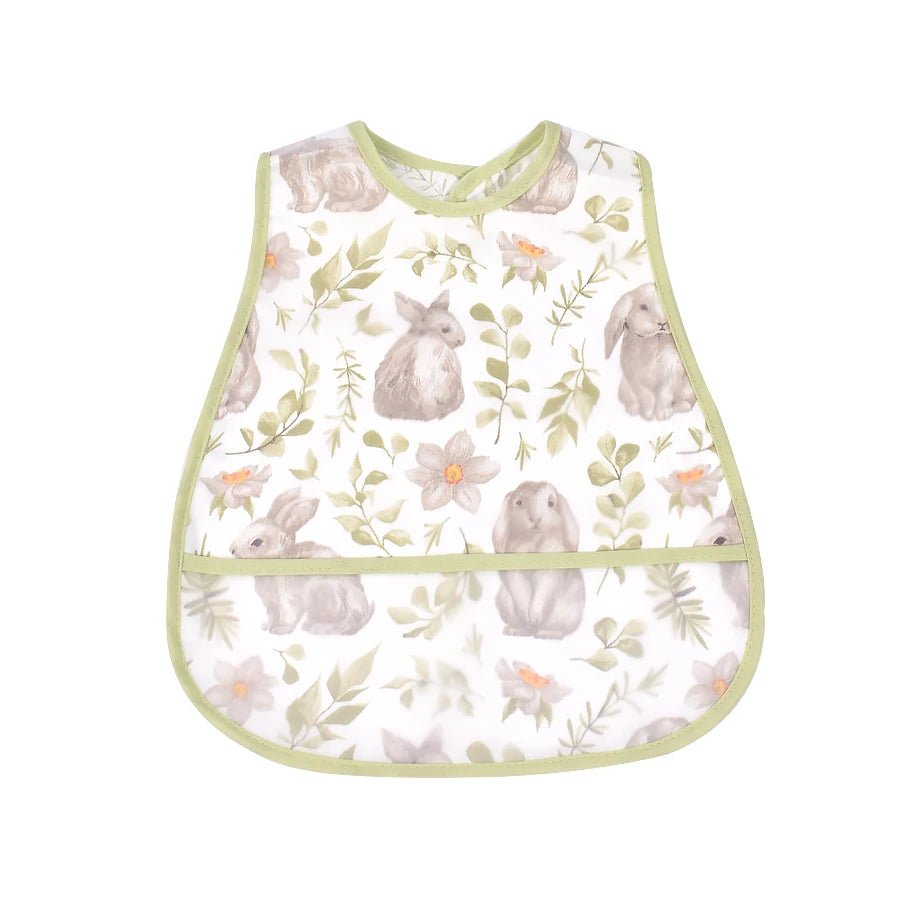 A light green baby feeding bib featuring a watercolor pattern of gray rabbits and green foliage.