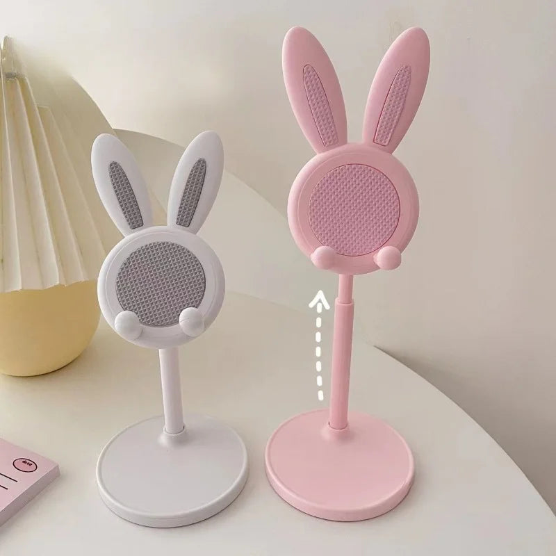 A pink rabbit-shaped stand for a mobile phone or tablet, featuring a padded surface and a vertical design.