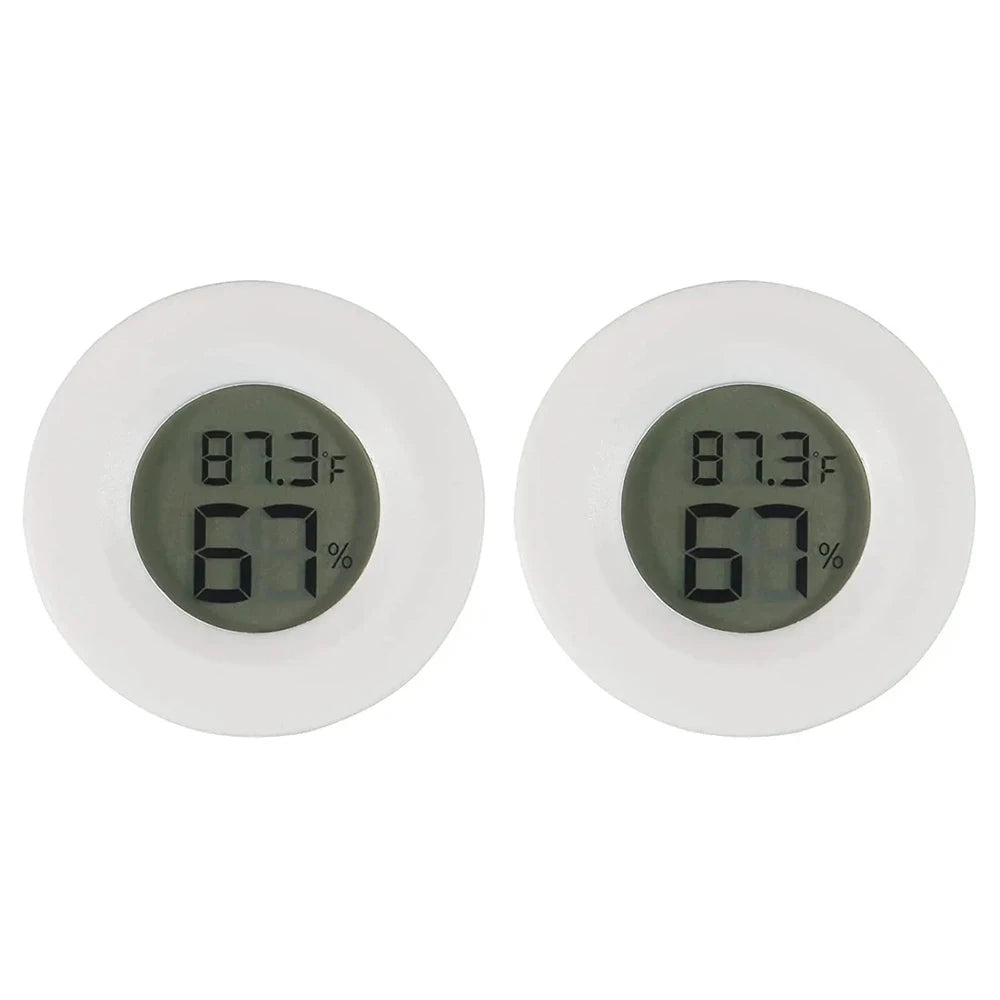 A pair of white mini digital hygrometer thermometers displaying 87.3°F and 67% humidity.