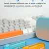 Two plastic fidget sliders, one blue and one orange, are shown on a blue surface next to a white keyboard.