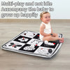 A happy baby sitting on a multi-play activity mat featuring various animal shapes and toys.