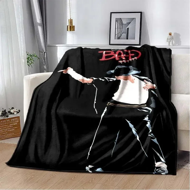 A black flannel throw blanket featuring a graphic print of Michael Jackson's name and silhouette.