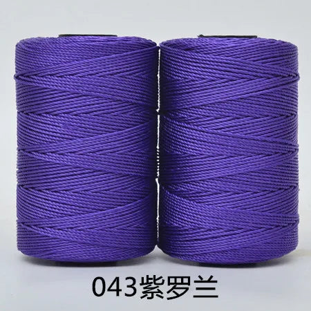 Two spools of purple 3-ply polyester knitting yarn for crochet and hand crafts