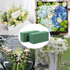 A square block of green floral foam used for flower arrangements.
