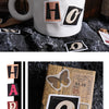 A white mug with a black and gold letter sticker design, next to a vintage alphabet sticker set.
