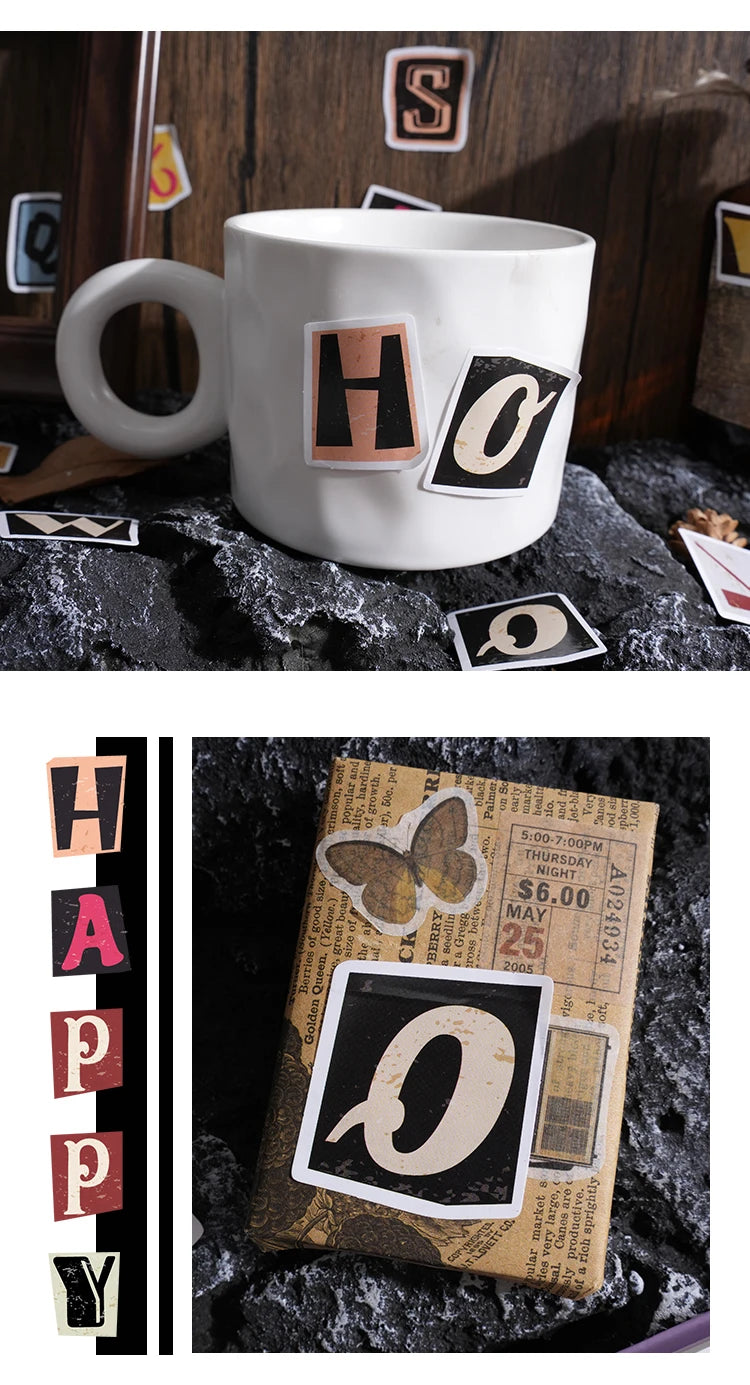 A white mug with a black and gold letter sticker design, next to a vintage alphabet sticker set.