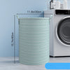 A tall, cylindrical striped laundry basket with handles is shown next to a washing machine.