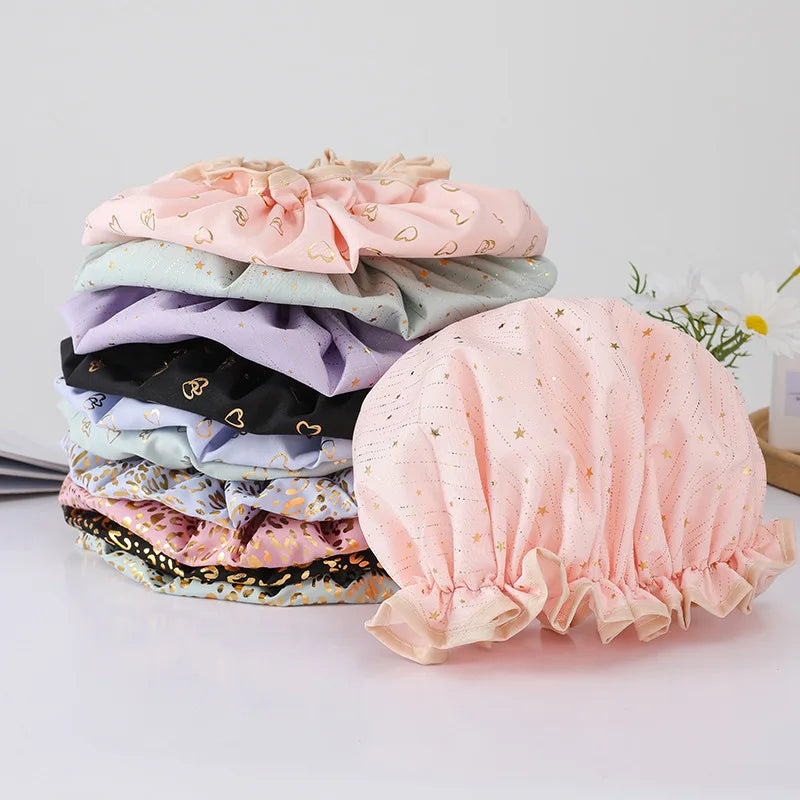 A stack of reusable elastic shower caps in various pastel colors including pink, lavender, and black.