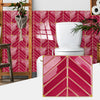 Glossy pink and white herringbone marble peel-and-stick tiles covering a bathroom wall.