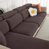 A dark gray jacquard elastic sofa slipcover with orange accent pillows on a white couch.