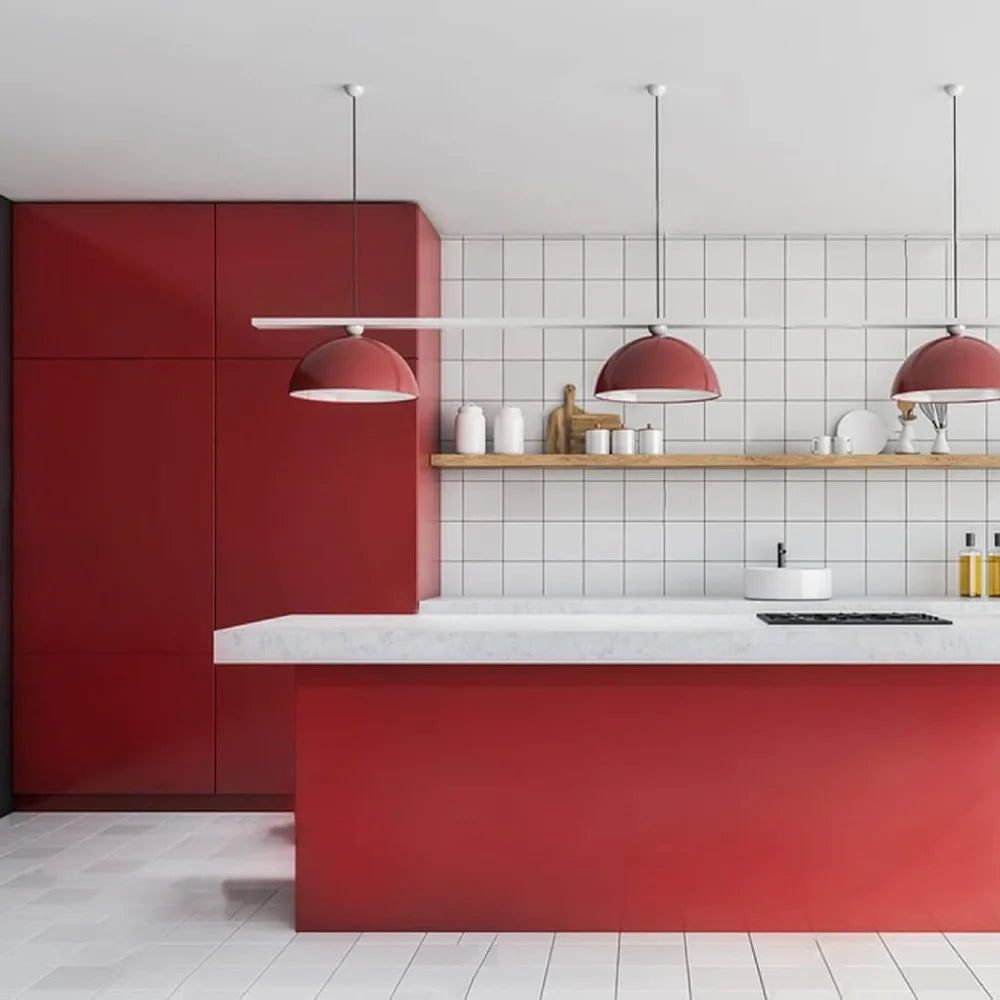 Modern kitchen featuring red cabinetry, white subway tile backsplash, and a red countertop.