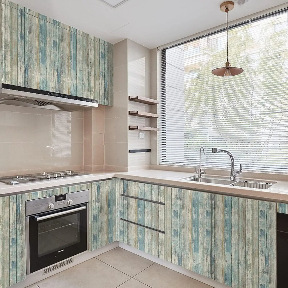 A modern kitchen featuring light wood grain peel and stick wallpaper on cabinetry and countertops.