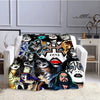 A printed flannel throw blanket featuring various iconic images of the Kiss band members.