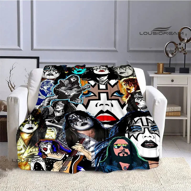 A printed flannel throw blanket featuring various iconic images of the Kiss band members.