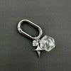 Silver keychain charm featuring a clear dice and a heart pendant attached to a D-shaped buckle.