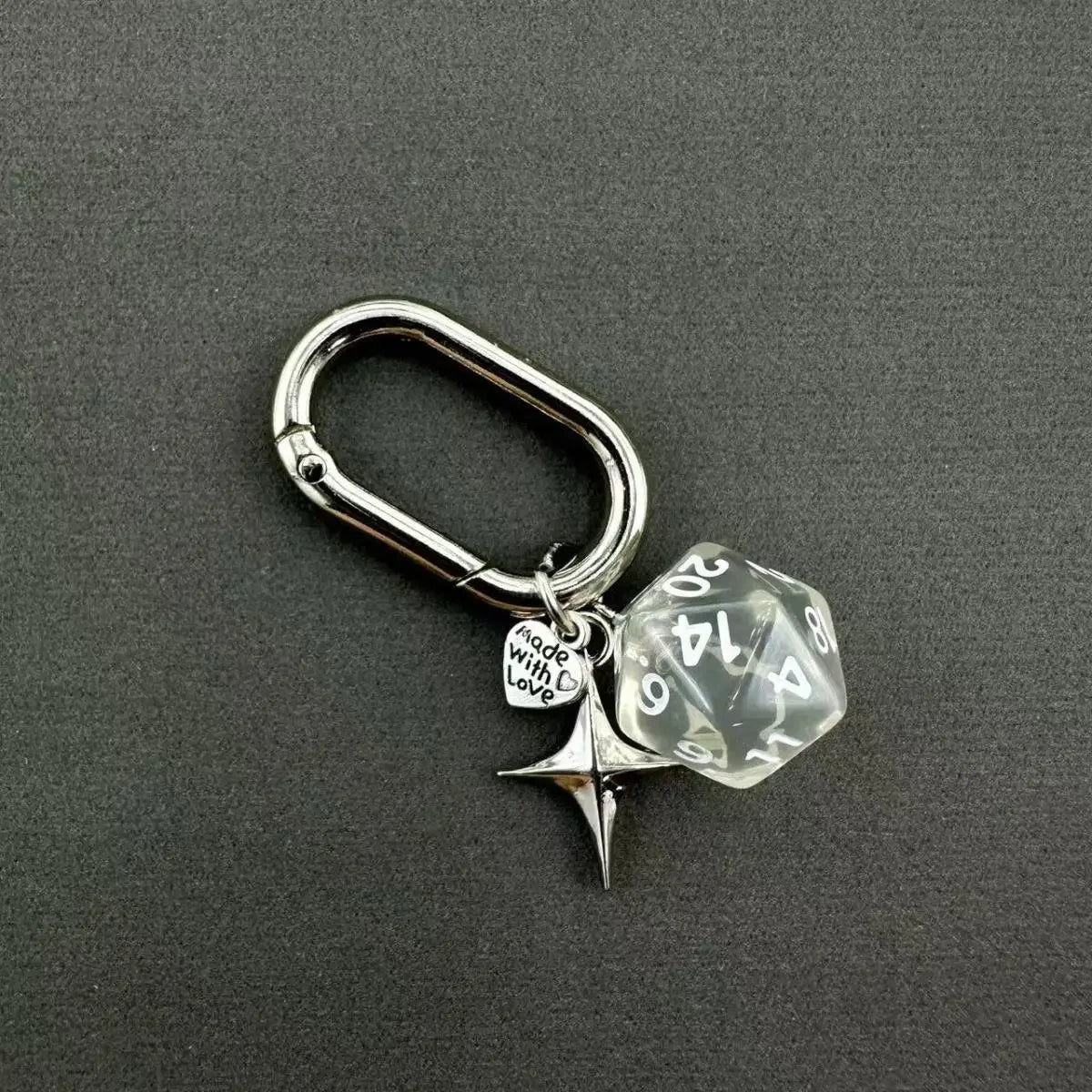Silver keychain charm featuring a clear dice and a heart pendant attached to a D-shaped buckle.