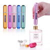 A hand holds a set of five colorful, travel-friendly refillable perfume spray bottles with gold and iridescent finishes.