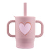 A pink silicone training cup with a straw and handles for baby.