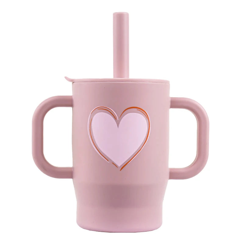 A pink silicone training cup with a straw and handles for baby.