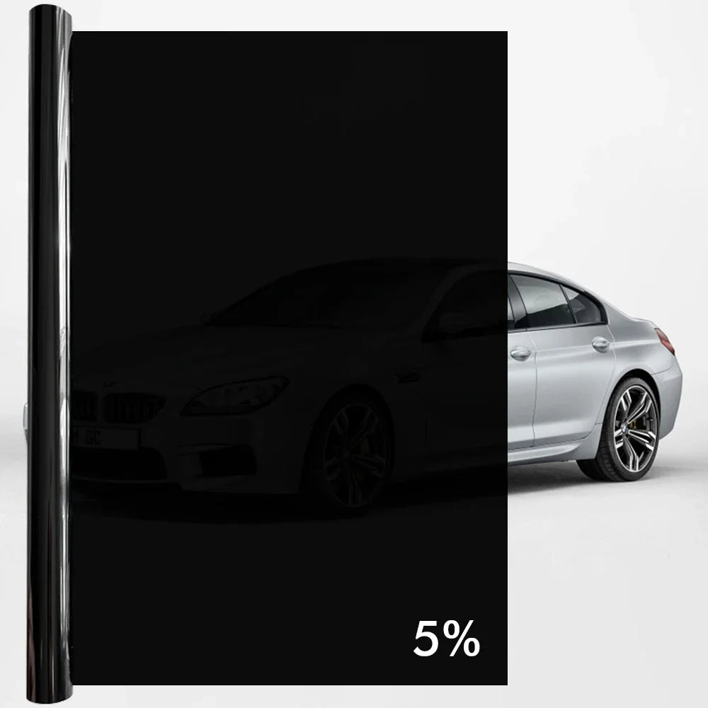 A black sedan is shown with a dark tint applied to the windows, demonstrating ceramic privacy film protection.