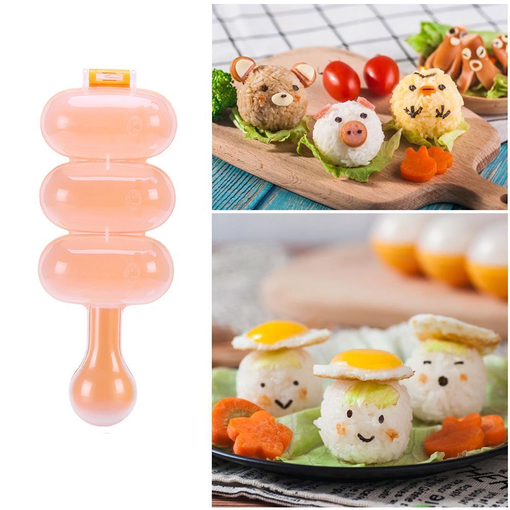 A pink rice ball mould shaker with a paddle is shown next to several prepared rice balls and vegetables.