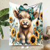 A fluffy Highland cow flannel blanket featuring a floral pattern and a bow charm.