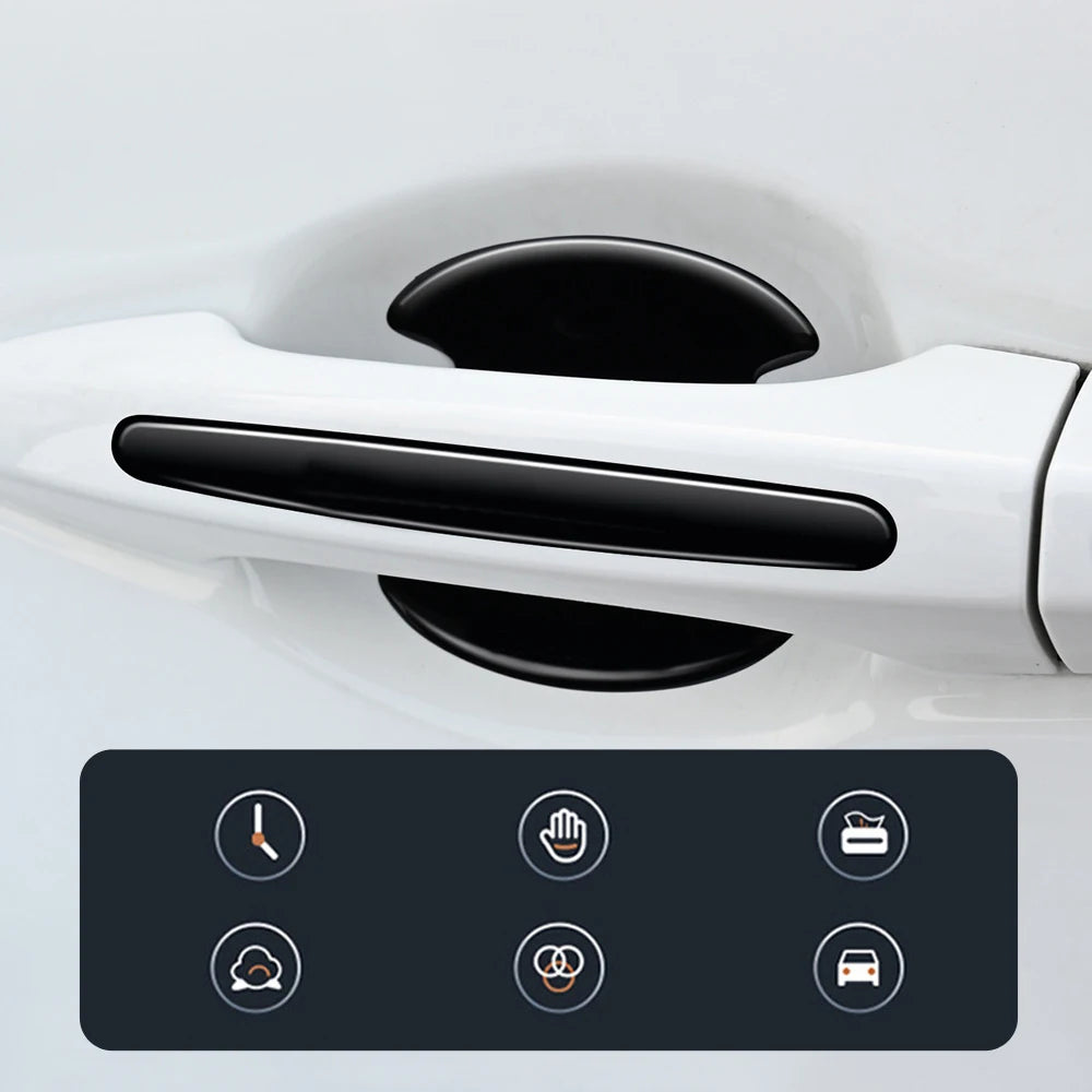 A close-up view of a white car door handle with a black protective film applied, showing various icons for features.