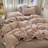 A beige floral duvet cover set with matching pillowcases and a flat sheet displayed on a bed.