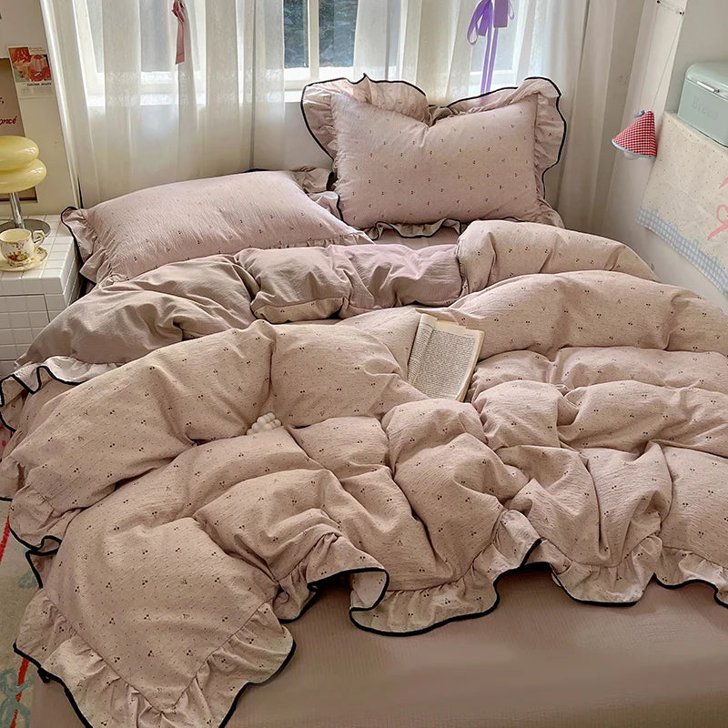 A beige floral duvet cover set with matching pillowcases and a flat sheet displayed on a bed.