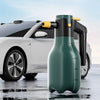 A green cordless electric foam sprayer bottle is positioned in front of a white car.