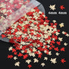 A pile of red and gold holographic star sequins for resin crafts, showing various sizes.
