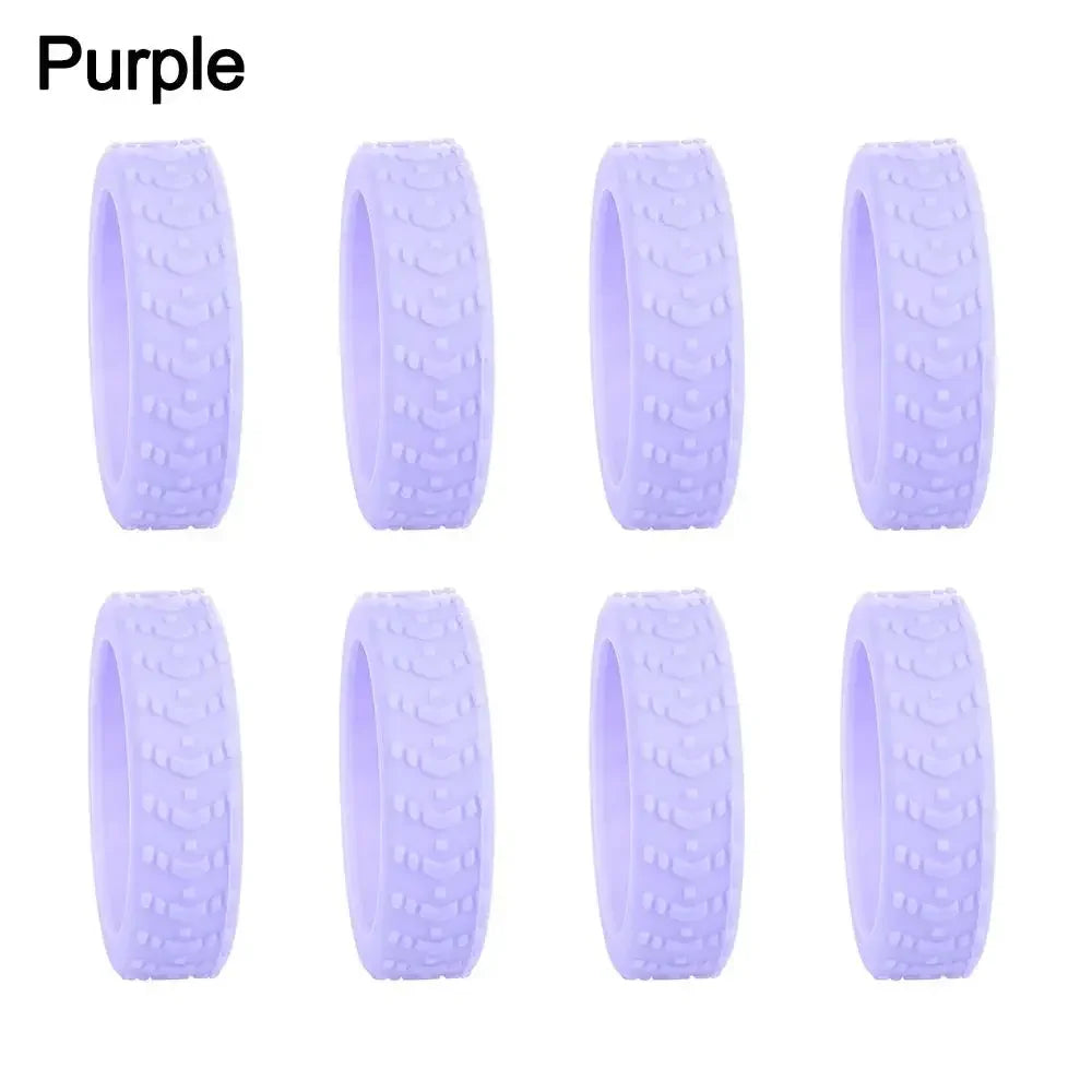 A set of purple silicone luggage wheel protectors designed to prevent scratching and reduce noise during travel.