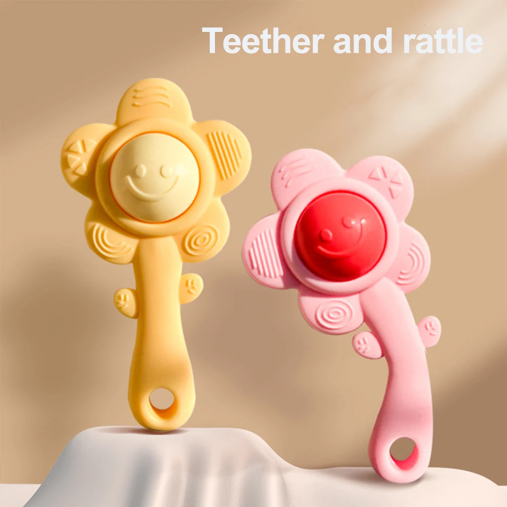 A yellow and pink 3-in-1 baby teether and rattle set with a chewable gripper and shaker toy