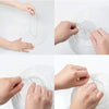 Hands are shown carefully placing thin wire into the center of a round white paper lantern.