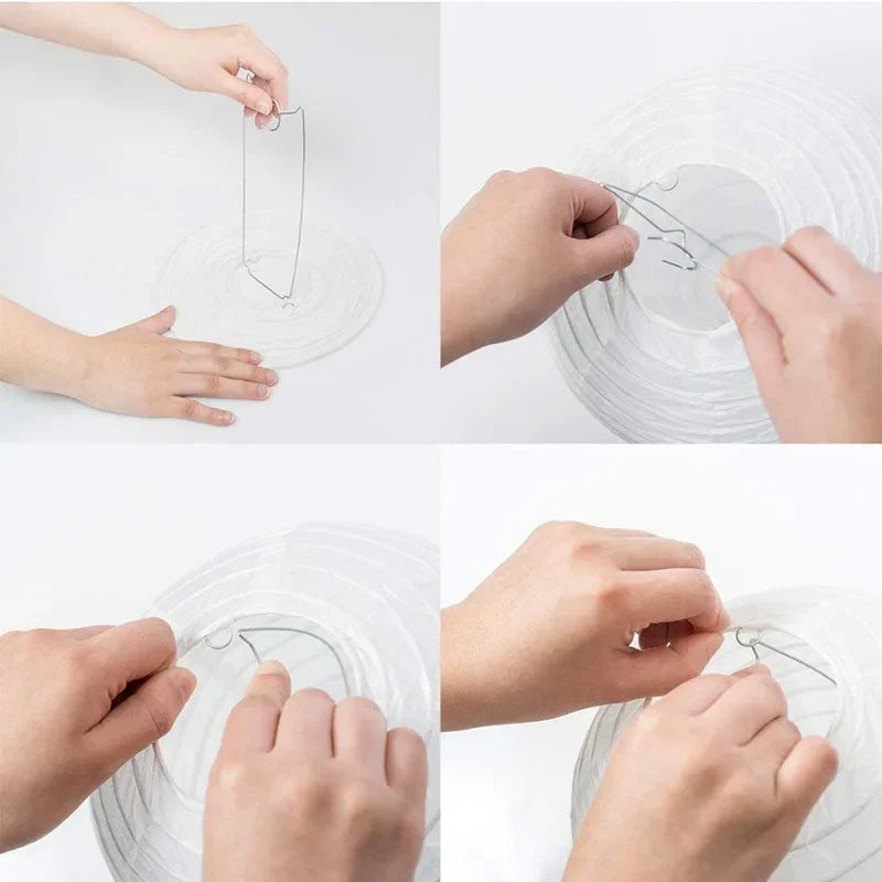 Hands are shown carefully placing thin wire into the center of a round white paper lantern.
