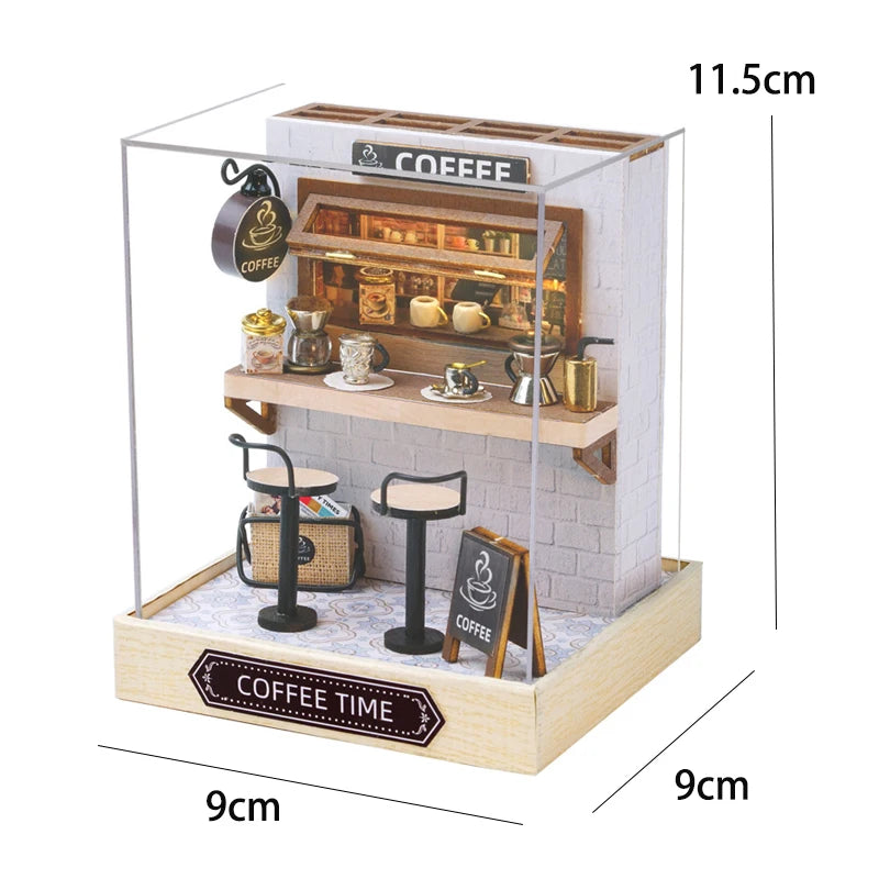 A wooden miniature coffee shop display featuring a counter, various cups and equipment, and an outdoor seating area.