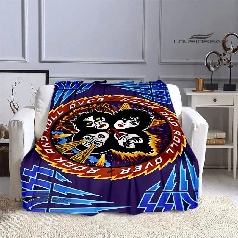 A purple and blue flannel throw blanket featuring a graphic design of the Kiss band logo.