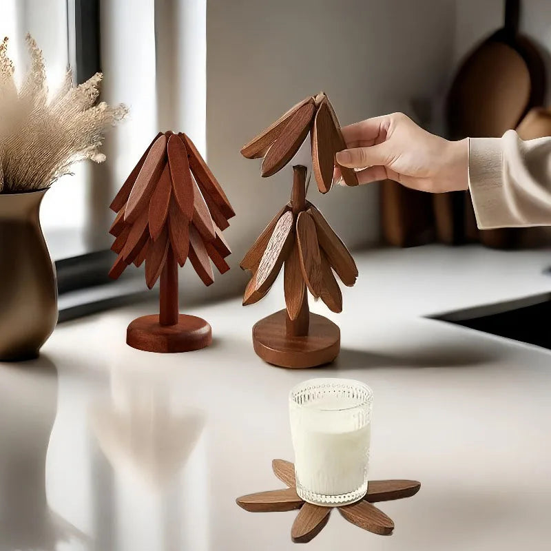 A set of wooden tree-shaped trivets, some in use and others displayed on a table.