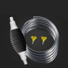 A clear plastic siphon pump with a white nozzle and yellow transfer funnels is shown against a dark background.