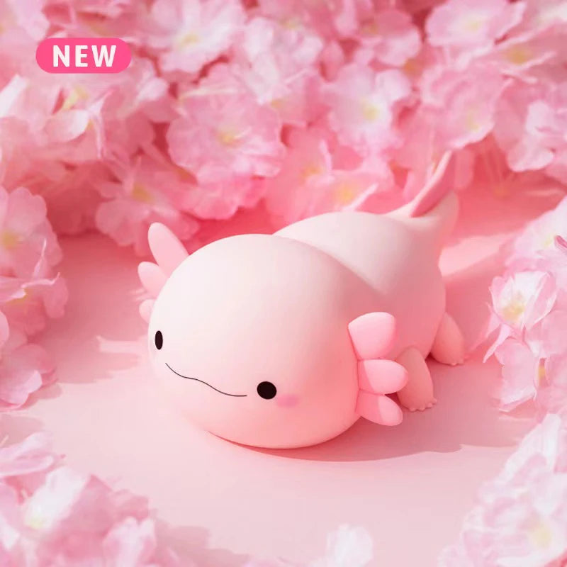 A pink cute axolotl night light with touch control and USB rechargeable battery resting on pink floral petals.