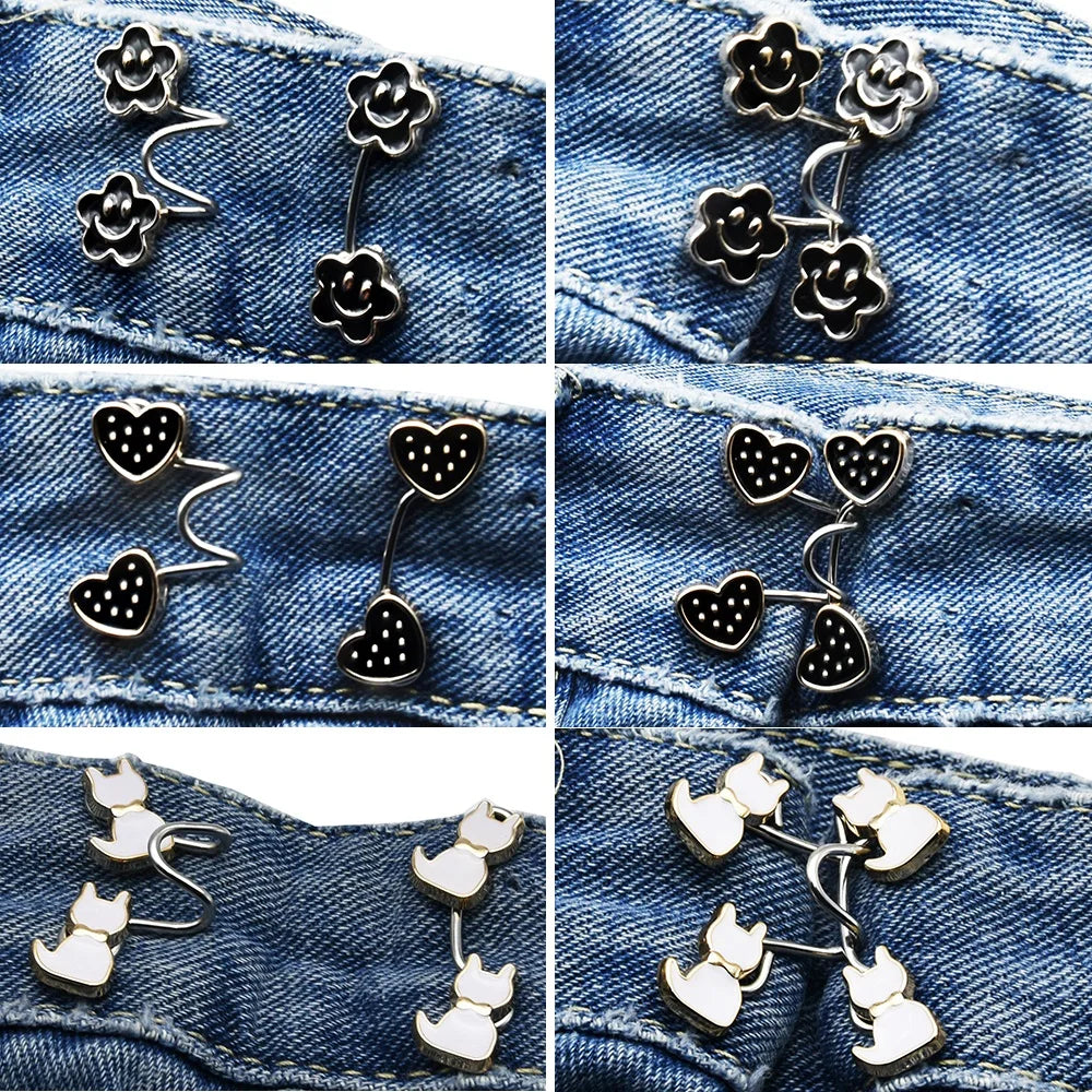 Close-up of various silver and gold no-sew adjustable buttons for tightening jeans, including floral, heart, and cat designs.