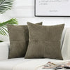 Two olive green corduroy patchwork throw pillow covers with vertical stitching on a white sofa.